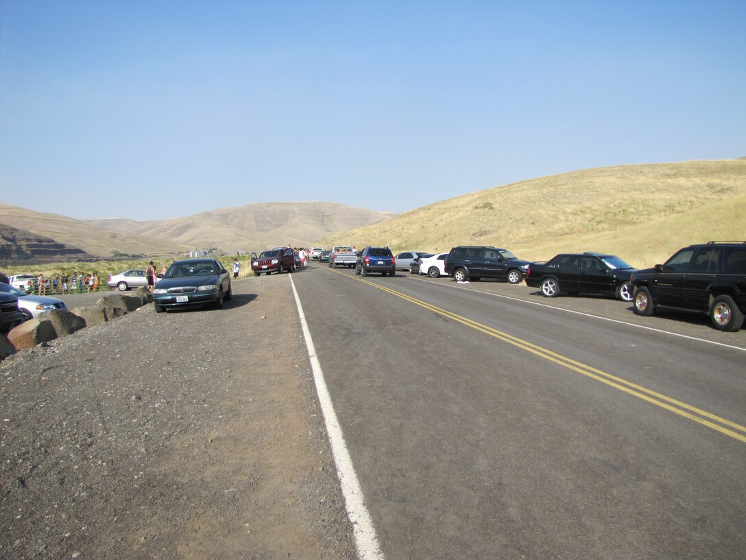 Parking on Almota Ferry Road near Illia Dunes has often been hazardous on warm-weather weekends. The speed limit is 50 mph. Visitors encroach on traffic lanes as they park on the shoulder, limiting the width available for cars and emergency vehicles to safely pass. Shoulder parking also creates a pedestrian hazard. U.S. Army Corps of Engineers photo.