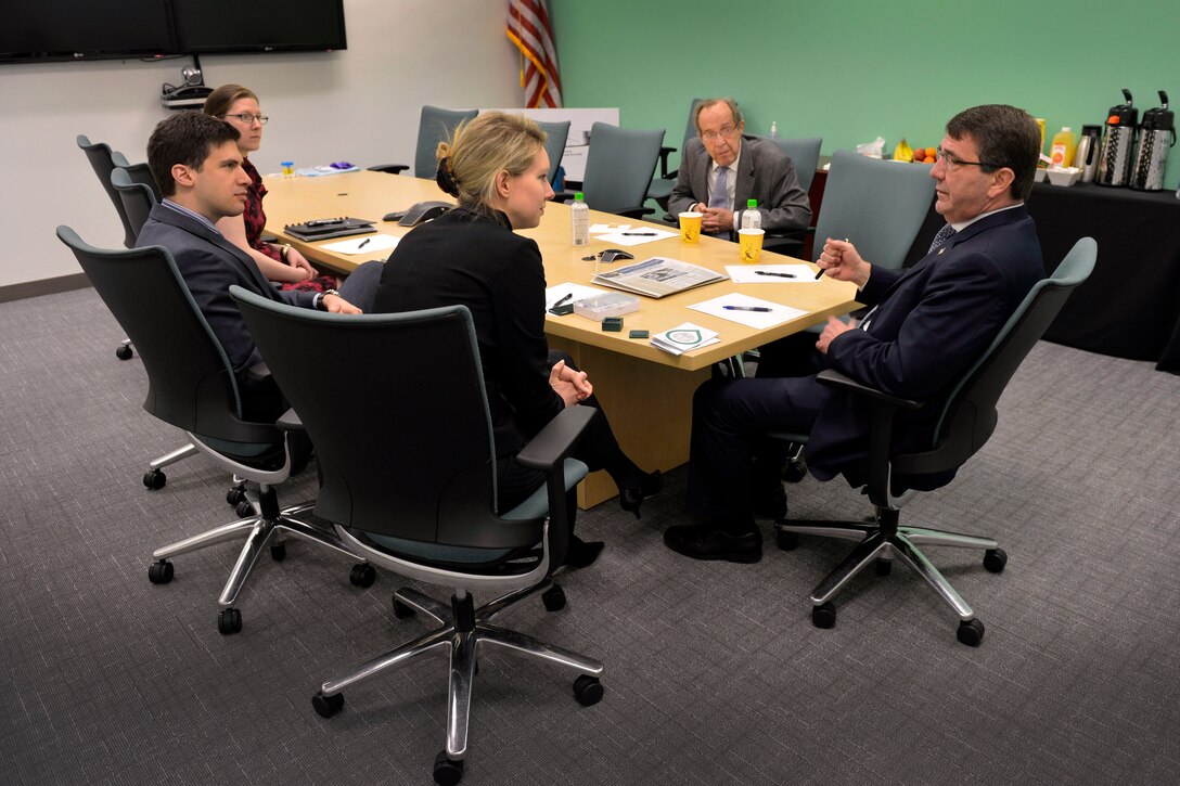 Deputy Defense Secretary Ash Carter, right, and former Defense Secretary William Perry, second from right, meet with Theranos CEO and founder Elizabeth Holmes during a series of visits to high-tech companies in Palo Alto, Calif., April 17, 2013.