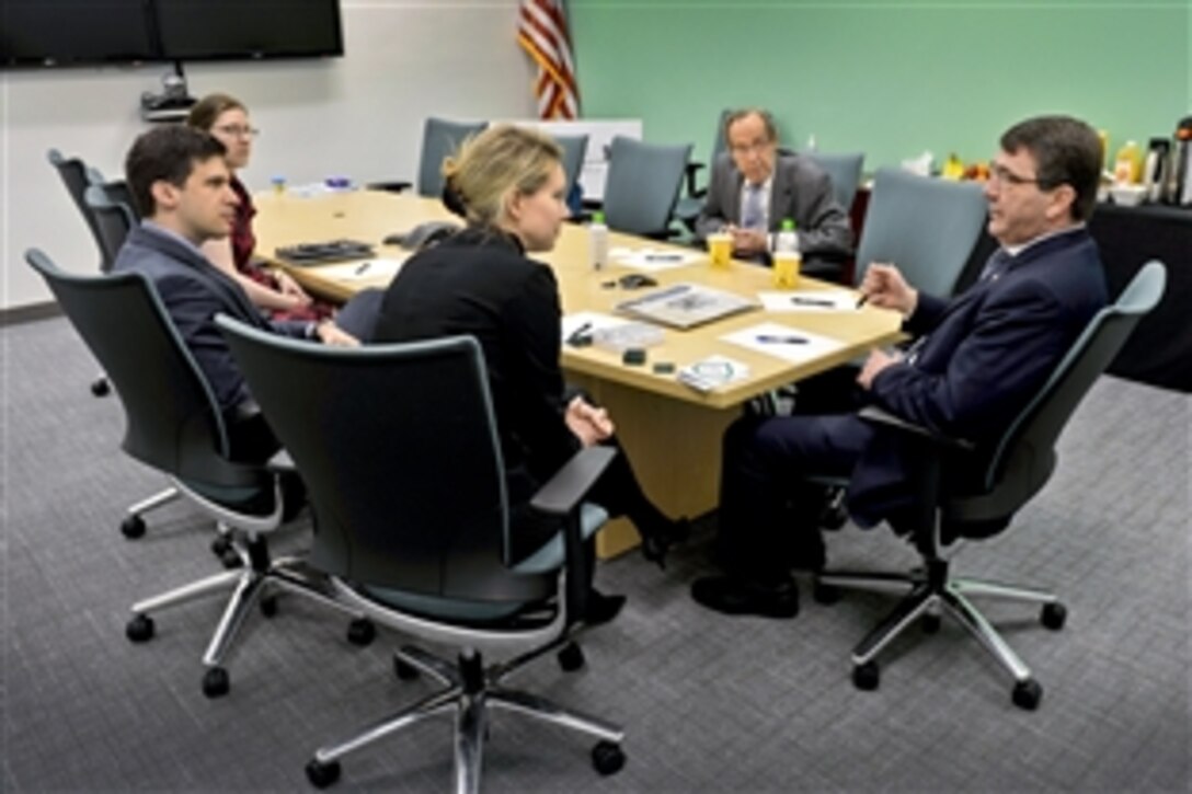 Deputy Defense Secretary Ash Carter, right, and former Defense Secretary William Perry, second from right, meet with Elizabeth Holmes, Theranos CEO and founder, during a series of visits to technology companies in Palo Alto, Calif., April 17, 2013.