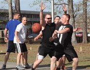 Servicemembers with Combat Logistics Battalion 2, 2nd Marine Logistics group engage in a game of basketball during a post-deployment field meet aboard Camp Lejeune, N.C., April 11, 2013.  The field meet was a way for Marines and sailors to have fun together before returning to work. (U.S. Photo by Lance Cpl. Shawn Valosin)