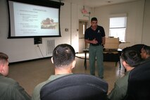 Bill Norton, an Ordnance Test Facility equipment specialist, teaches members of the Marine Corps Base Quantico Special Reaction Team how to operate the M45A1 Close Quarters Battle Pistol during a New Equipment Training class April 10. The pistol replaces the Marine Expeditionary Unit (Special Operations Capable) .45-caliber pistol, and will be fielded to Marine Corps Special Operations Command, reconnaissance organizations and military police special response teams across the Marine Corps.