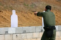 Officer David Wilkinson, a member of the Marine Corps Base Quantico Special Response Team, fires the M45A1 Close Quarters Battle Pistol during a New Equipment Training class April 10. The pistol replaces the Marine Expeditionary Unit (Special Operations Capable) .45-caliber pistol, and will be fielded to Marine Corps Special Operations Command, reconnaissance organizations and military police special response teams across the Marine Corps.
