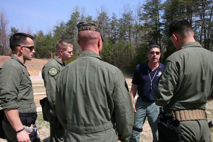 Bill Norton, an Ordnance Test Facility equipment specialist, talks to members of the Marine Corps Base Quantico Special Reaction Team following a New Equipment Training class for the M45A1 Close Quarters Battle Pistol April 10. The pistol replaces the Marine Expeditionary Unit (Special Operations Capable) .45-caliber pistol, and will be fielded to Marine Corps Special Operations Command, reconnaissance organizations and military police special response teams across the Marine Corps.