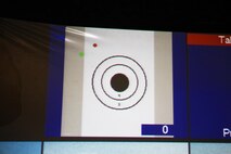 A projector shows where a shot hit the target during a base tour aboard Camp Lejeune, N.C., April 18, 2013. The indoor simulated marksmanship trainer showed naval JROTC students from Greensboro, N.C., where the shots hit the target seconds after fired. 