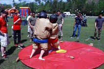Marines with Combat Logistics Battalion 6, 2nd Marine Logistics Group fight in sumo wrestling suits at Soifert field during a family day aboard Camp Lejeune, N.C., April 17, 2013. Servicemembers and their families enjoyed each other’s company playing games, such as corn hole, a soccer competition and tricycle races before going to Marine Corps Air Ground Combat Center Twenty-nine Palms for pre-deployment training in the near future. 