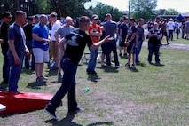 A Marine with Combat Logistics Battalion 6, 2nd Marine Logistics Group tosses a sandbag during a game of corn hole at Soifert Field during a family day aboard Camp Lejeune, N.C., April 17, 2013. Friends and family of servicemembers played games and enjoyed food before the battalion deploys later in the year. 