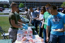 Marines and sailors with Combat Logistics Battalion 6, 2nd Marine Logistics Group serve food to servicemembers with the battalion during a family day at Soifert field aboard Camp Lejeune, N.C., April 17, 2013. Troops and their families enjoyed the day playing games, eating food and participating in competitions.