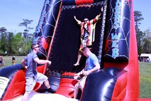 Marines with Combat Logistics Battalion 6, 2nd Marine Logistics Group throw a Marine on the fabric fastener wall during a family day at Soifert field aboard Camp Lejeune, N.C., April 17, 2013. The event was one of the largest the battalion has put together for servicemembers and their families. 