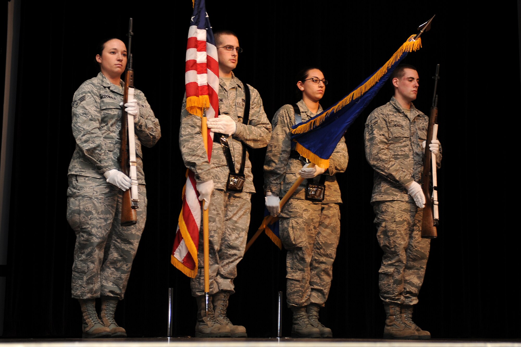 Base Honor Guard Airmen from Seymour Johnson Air Force Base present the colors during a Retreat Ceremony and Roll Call at the base theatre on Seymour Johnson Air Force Base, N.C., April 12, 2013. In line with the F-15E Strike Eagle 25th Anniversary, Airmen from across the globe and the decades, paid respect to the legacy of the 14 aircrew members that perished while flying the F-15E Strike Eagle. (U.S. Air Force photo by Airman 1st Class John Nieves Camacho/Released)