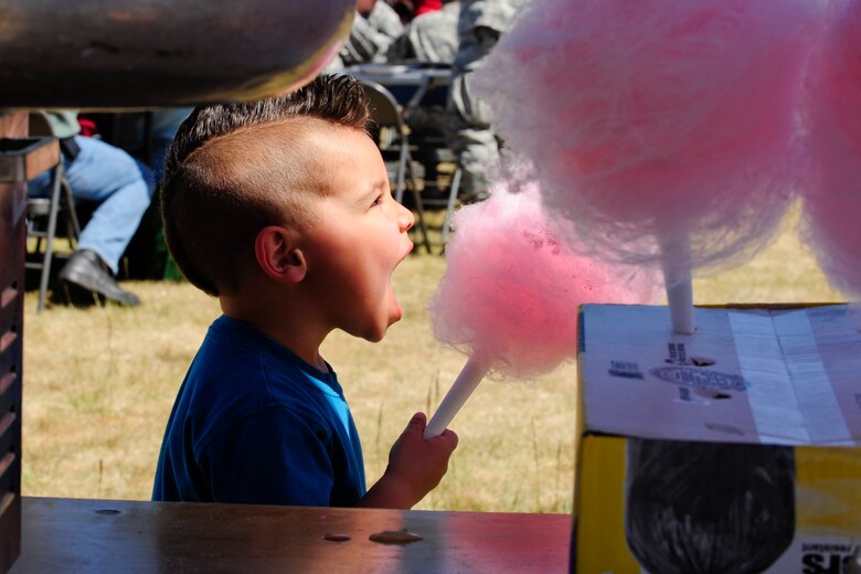 VANDENBERG AIR FORCE BASE, Calif. – Joshua Neddo, 3 year old son of Staff Sgt. Matthew Neddo, Joint Functional Component Command Space intelligence analyst, takes a bite out of a cotton candy ball during the 13th annual Earth Day event here Thursday, April 18, 2013. Celebrated by millions of people on April 22, Earth Day promotes awareness and appreciation for the environment. (U.S. Air Force photo/Airman Yvonne Morales)