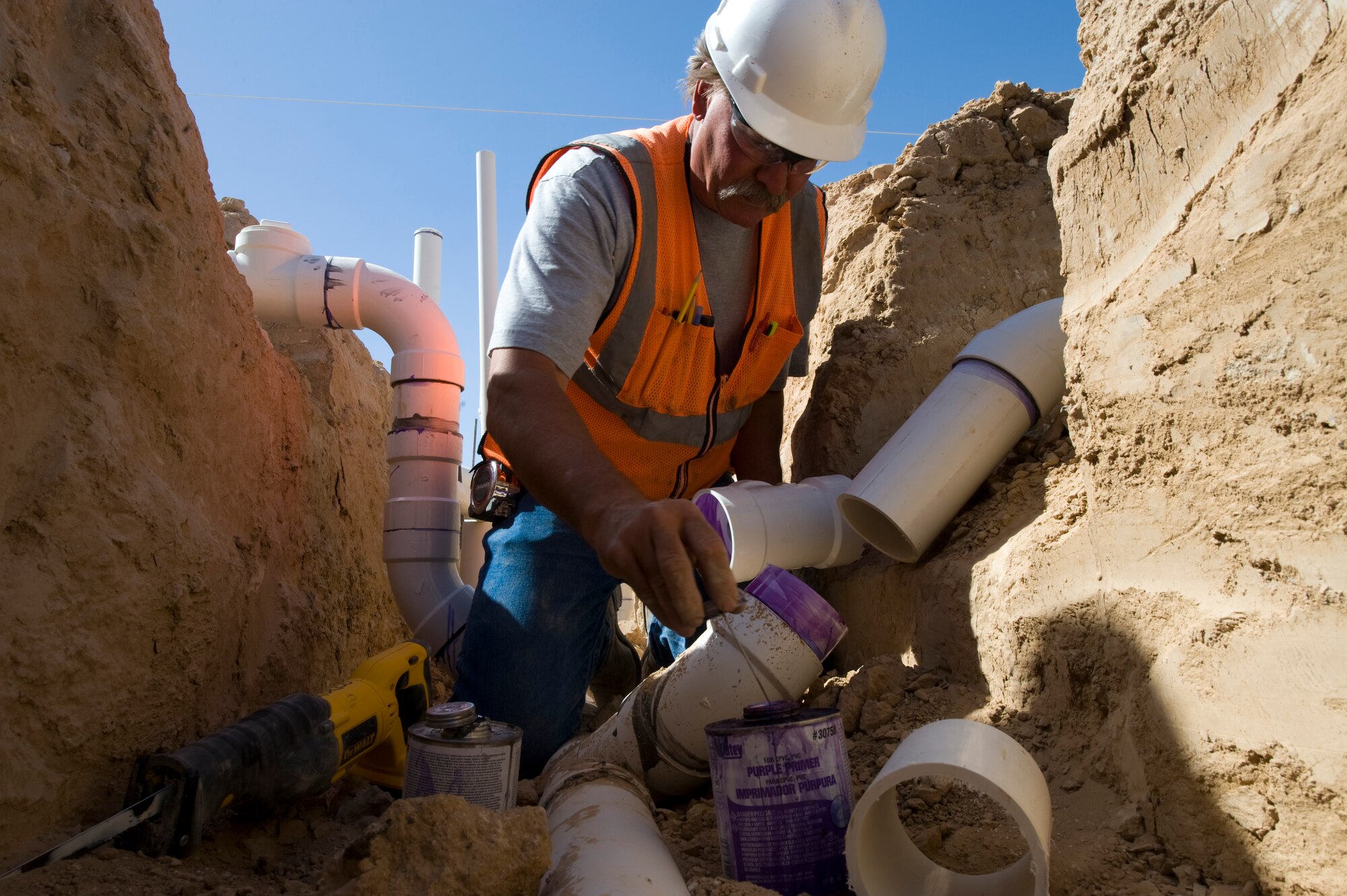 A contract plumber connects pipes at the aerospace ground equipment facility April 15, 2013, at Nellis Air Force Base, Nev. The AGE facility will house ground equipment for the F-35A Lightning II. (U.S. Air Force photo by Airman 1st Class Christopher Tam)