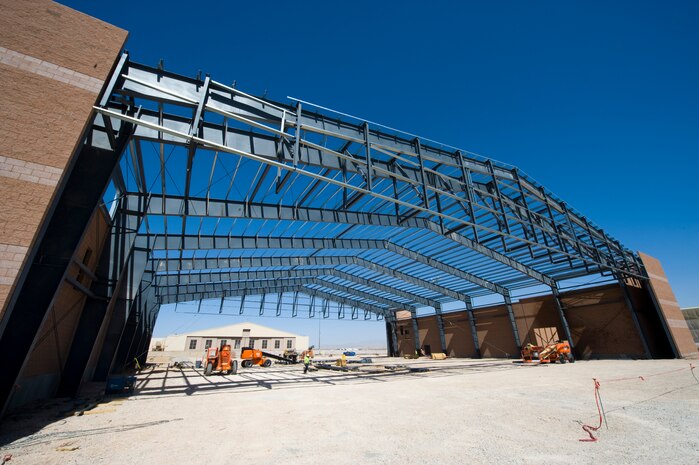Construction workers build an F-35A Lightning II Maintenance Hangar near the flight line April 15, 2013, at Nellis Air Force Base, Nev. The construction is scheduled to be done in November 2013. (U.S. Air Force photo by Airman 1st Class Christopher Tam)