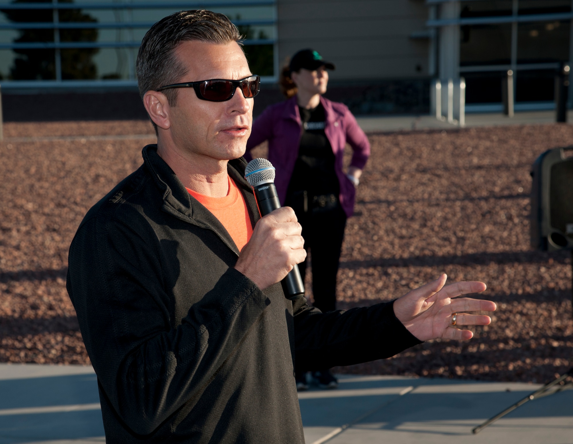 Col. Barry Cornish, 99th Air Base Wing commander, delivers opening remarks before the start of the Survive and Thrive 5-kilometer  run April 19, 2013, at Nellis Air Force Base, Nev. The event was coordinated by the sexual assault response coordinator, mental health, and the Warrior Fitness Center to promote mental wellness and wingman ship. (U.S. Air Force photo by Master Sgt. Jason W. Edwards)