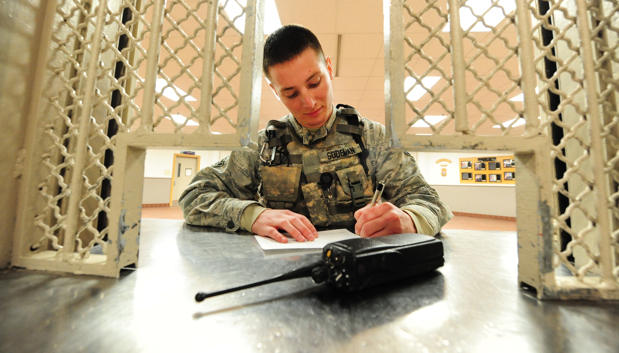 Airman Robert Sodeman, 509th Security Forces Squadron response force member, signs a hand receipt for a land mobile radio at the armory prior to the start of a 12-hour shift at Whiteman Air Force Base, Mo., March 25, 2013. The armory provides base personnel with the arms and equipment they need in their line of duty. (U.S. Air Force photo by Staff Sgt. Nick Wilson/Released)