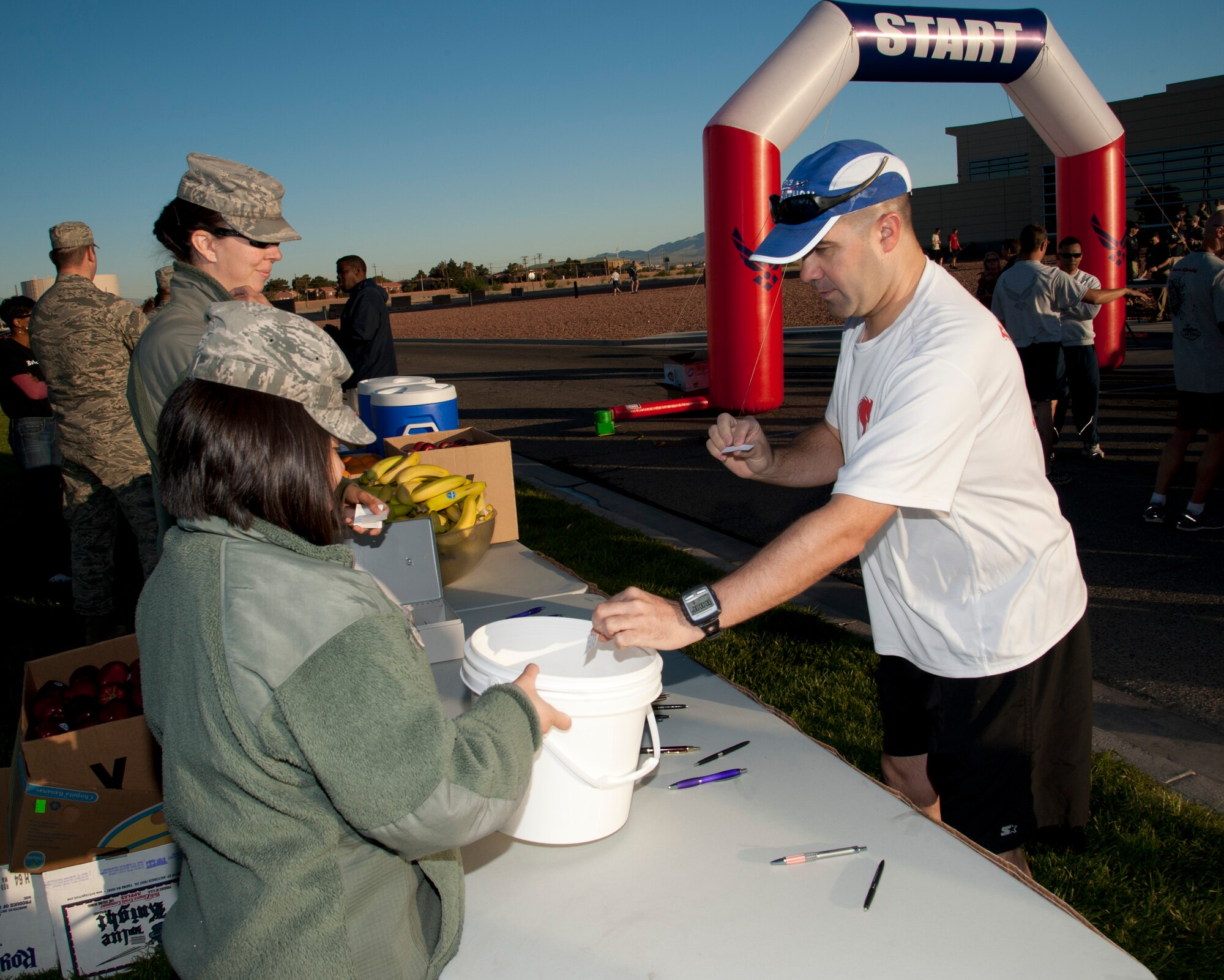 Tech. Sgt. Michael Ballard, 820th RED HORSE Squadron commander’s support staff NCO in charge, enters a raffle prior to running in the Survive and Thrive 5-kilometer April 19, 2013, at Nellis Air Force Base, Nev. The 5-kilometer event was held at the Warrior Fitness Center to promote mental well-being and awareness. (U.S. Air Force photo by Master Sgt. Jason W. Edwards)