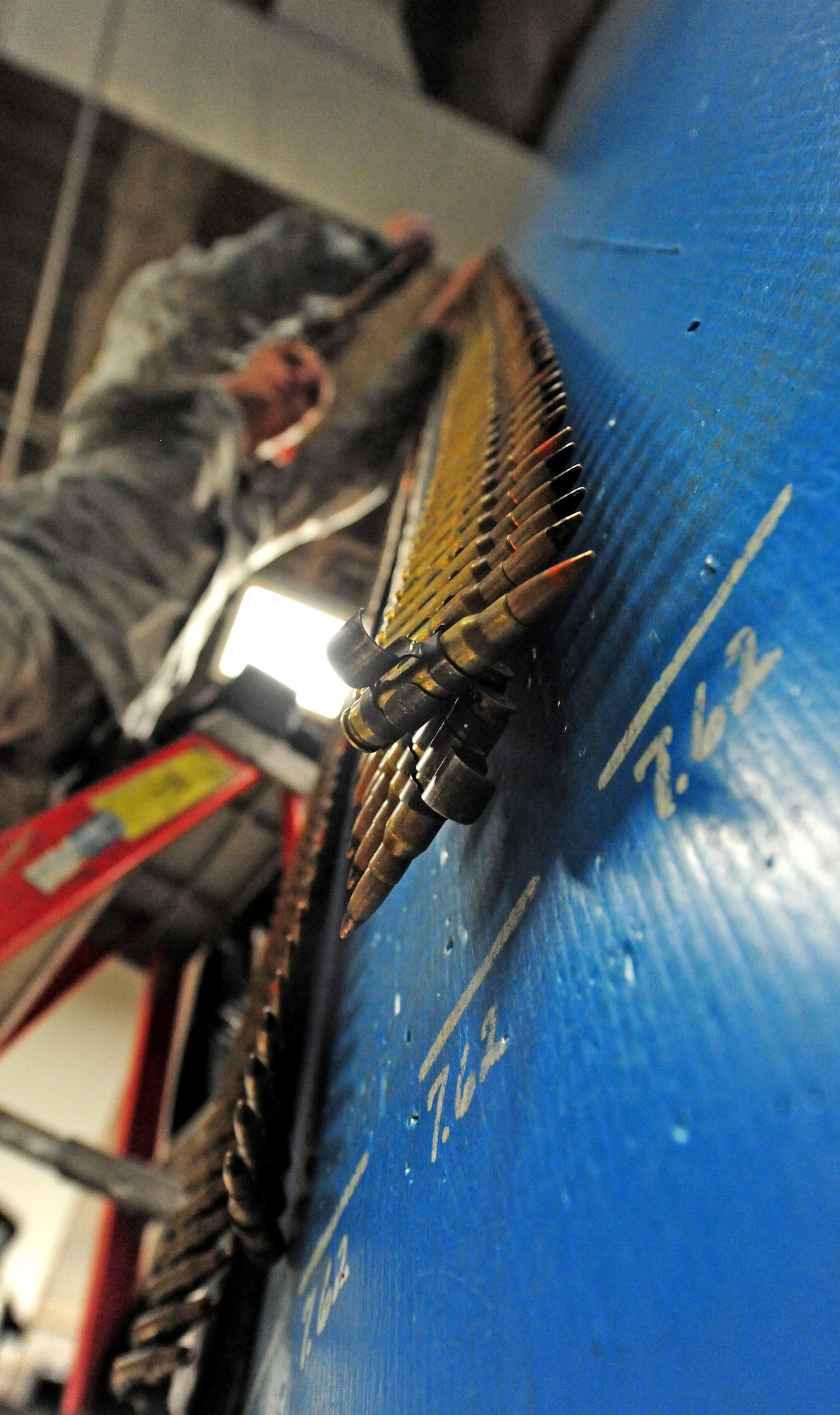 Airman Brandon Swisher, 509th Security Forces Squadron response force member, stores M240 machine gun rounds in the armory before being relieved from his 12-hour shift at Whiteman Air Force Base, Mo., March 25, 2013. More than $5 million in equipment is housed within the armory. (U.S. Air Force photo by Staff Sgt. Nick Wilson/Released)