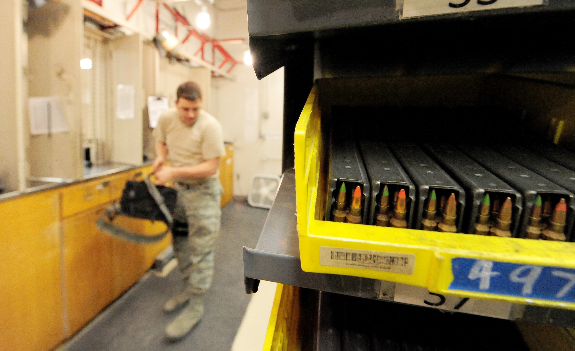 Senior Airman Brian Winker, 509th Security Forces Squadron armorer, organizes equipment in the armory before issuing it to customers, Whiteman Air Force Base, Mo., March 25, 2013. Winker is responsible for securing all the armory's assets, accounting for weapons, ammunition and equipment valuing more than $5 million. (U.S. Air Force photo by Staff Sgt. Nick Wilson/Released) 