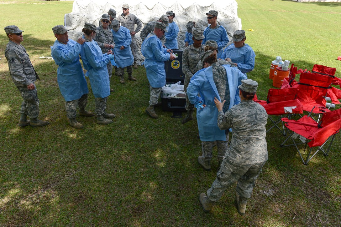 National Guard Airmen don personal protective equipment in preparation for a search and recovery exercise, April 18, 2013 at Savannah Air National Guard base in Garden City, Ga. (National Guard photo by Tech. Sgt. Charles Delano/released)