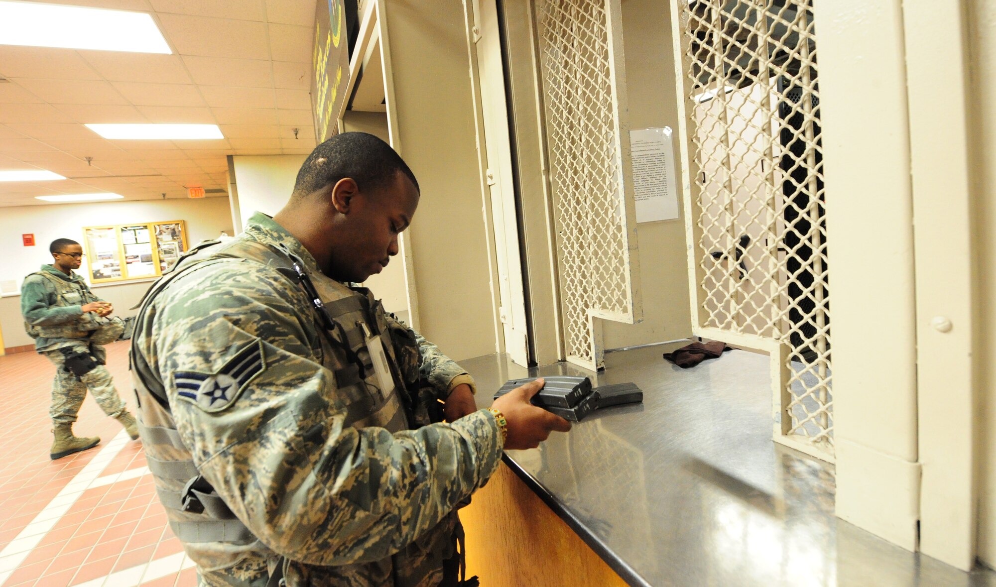 Senior Airman John Harris, 509th Security Forces Squadron response force member, stows away M4 carbine magazines just before reporting to his assigned post at Whiteman Air Force Base, Mo., March 25, 2013. Members working in the armory are accountable for every weapon and piece of ammunition issued to security forces Airmen. (U.S. Air Force photo by Staff Sgt. Nick Wilson/Released) 