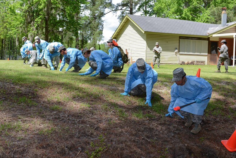 National Guard Airmen search for parial remains and personal effects during a search and recovery exercise, April 18, 2013 at Savannah Air National Guard base in Garden City, Ga. (National Guard photo by Tech. Sgt. Charles Delano/released)