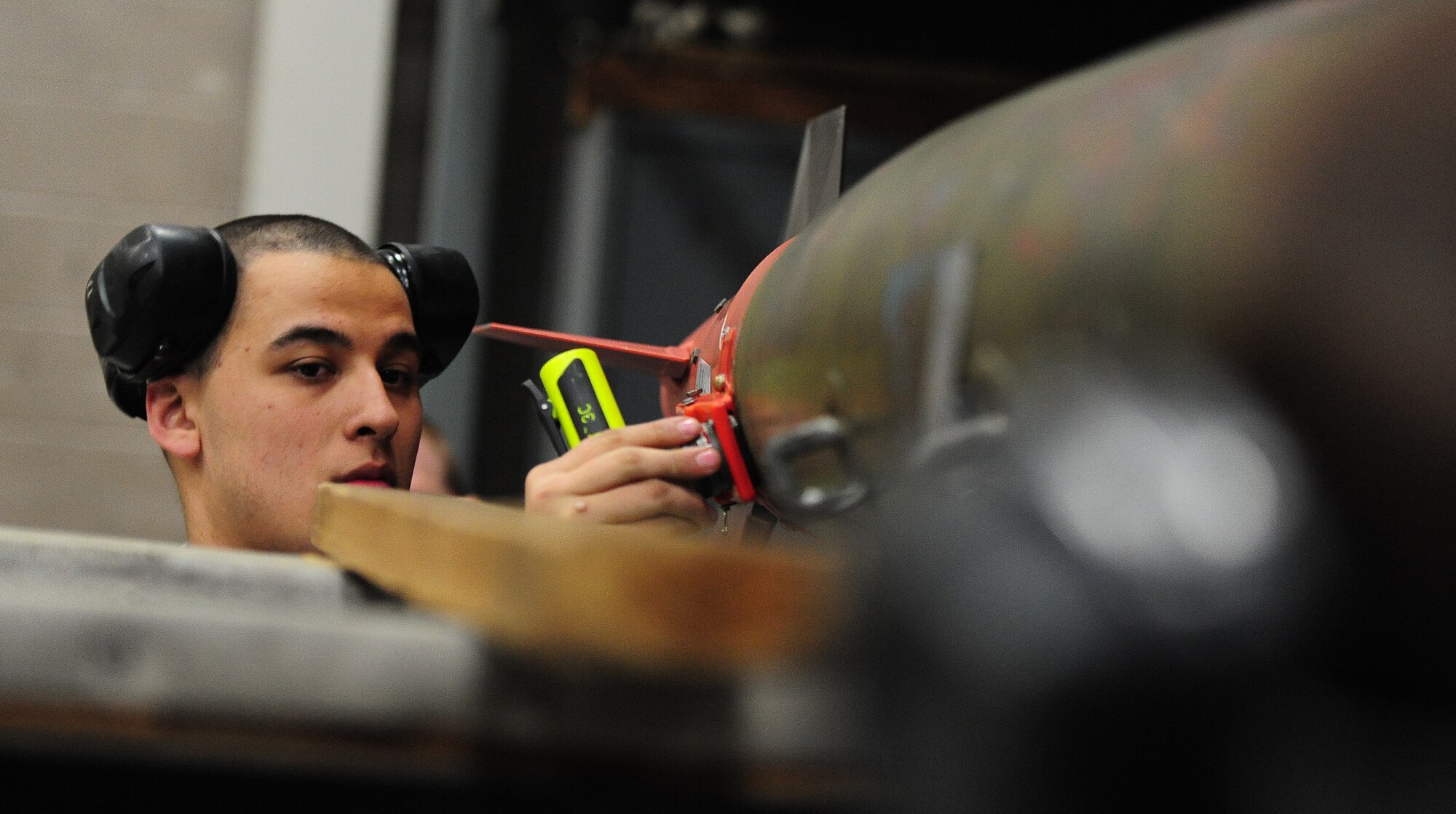 Airman 1st Class Jacob White, 13th Aircraft Maintenance Unit weapons loader, inspects munitions during a weapons load competition at Whiteman Air Force Base, Mo., April 12, 2013. The competition showed how each team meshed together to ensure weapons were loaded in a timely manner. (U.S. Air Force photo by Staff Sgt. Nick Wilson/Released)