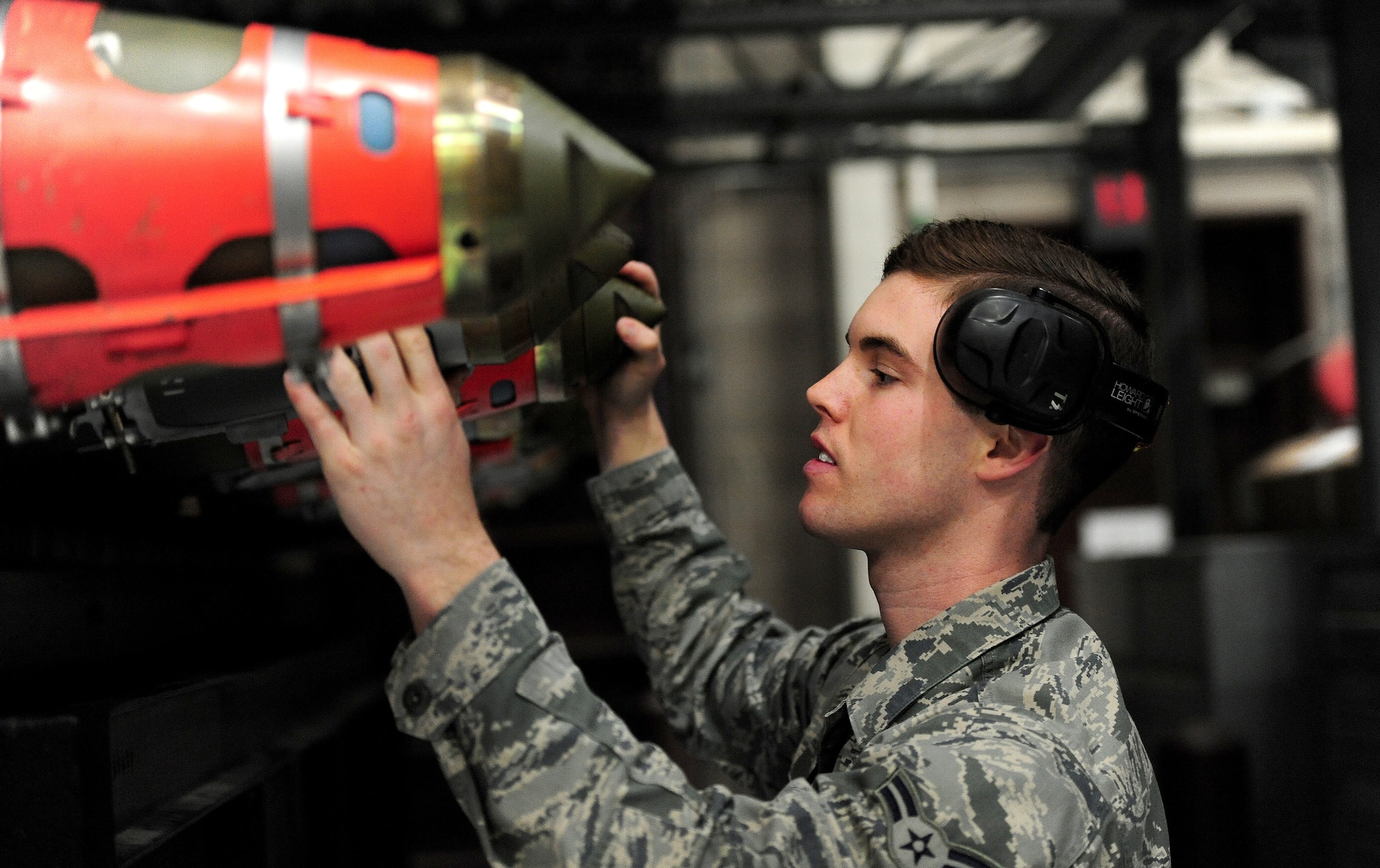 Airman 1st Class Justin Sutherland, 13th Aircraft Maintenance Unit weapons loader, inspects munitions during a weapons load competition at Whiteman Air Force Base, Mo., April 12, 2013. Airmen from Whiteman’s 13th and 393rd Aircraft Maintenance Units competed in the first-quarter Load Crew of the Quarter competition that showcased the teamwork, precision and attention to detail among Airmen in support of nuclear deterrence and global strike operations. (U.S. Air Force photo by Staff Sgt. Nick Wilson/Released)