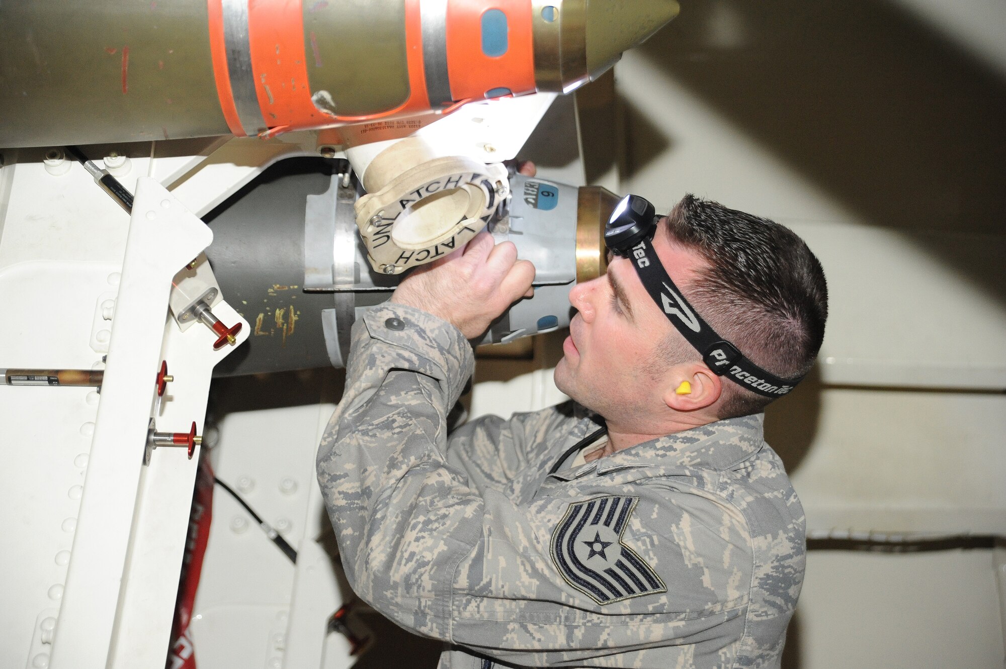 Tech. Sgt.  Dustin Guidry, 13th Aircraft Maintenance Unit weapons load team chief, loads a munition into the weapons bay of a B-2 Spirit before competing in the first-quarter Load Crew of the Quarter competition at Whiteman Air Force Base, Mo., April 12, 2013. Weapons load competitions are used to showcase the speed, precision and attention to detail with which weapons loaders perform their tasks. (U.S. Air Force photo by Staff Sgt. Nick Wilson/Released)