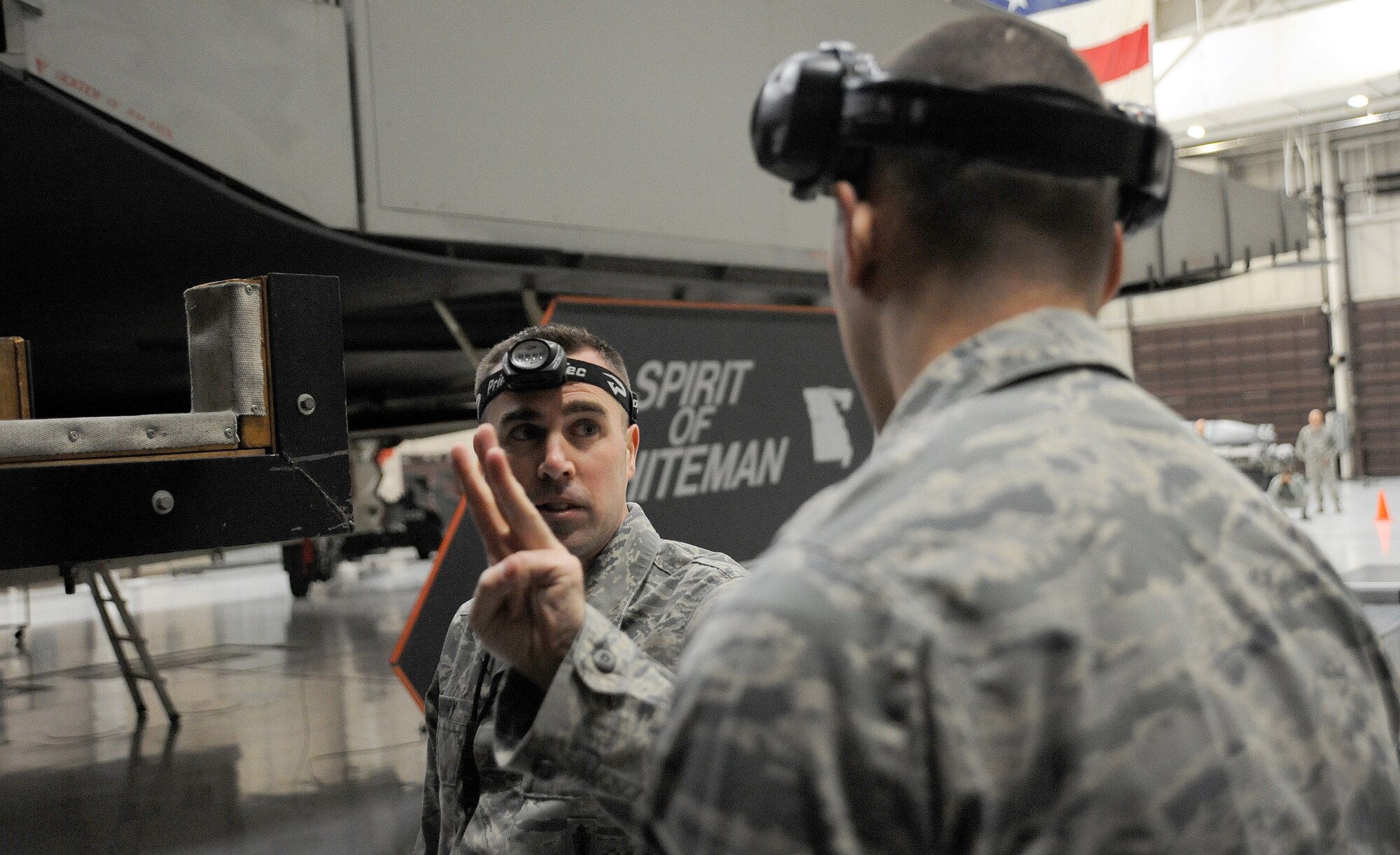 Tech. Sgt.  Dustin Guidry, 13th Aircraft Maintenance Unit weapons load team chief, discusses load procedures with Airman 1st Class Jacob White, 13th AMU weapons loader, before competing in the first-quarter Load Crew of the Quarter competition at Whiteman Air Force Base, Mo., April 12, 2013. Guidry’s team finished second in the competition. (U.S. Air Force photo by Staff Sgt. Nick Wilson/Released)