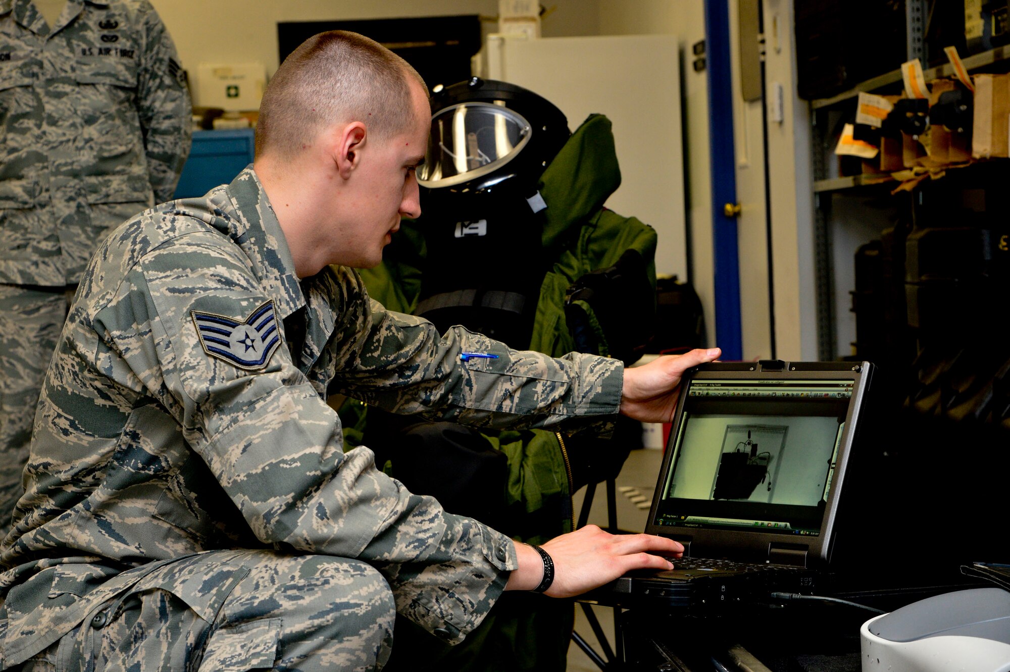 Staff Sgt. Benjamin McGovern, from the 436th Civil Engineer Squadron Explosive Ordnance Disposal Flight, demonstrates the XRS-300 portable X-ray system used by him and his team to render explosives safe at Dover Air Force Base, Del., April 16, 2013. The Media Day was an opportunity for media representatives to get a closer look at and a better understanding of Dover AFB's EOD Airmen and mission.  (U.S. Air Force photo/David S. Tucker)
