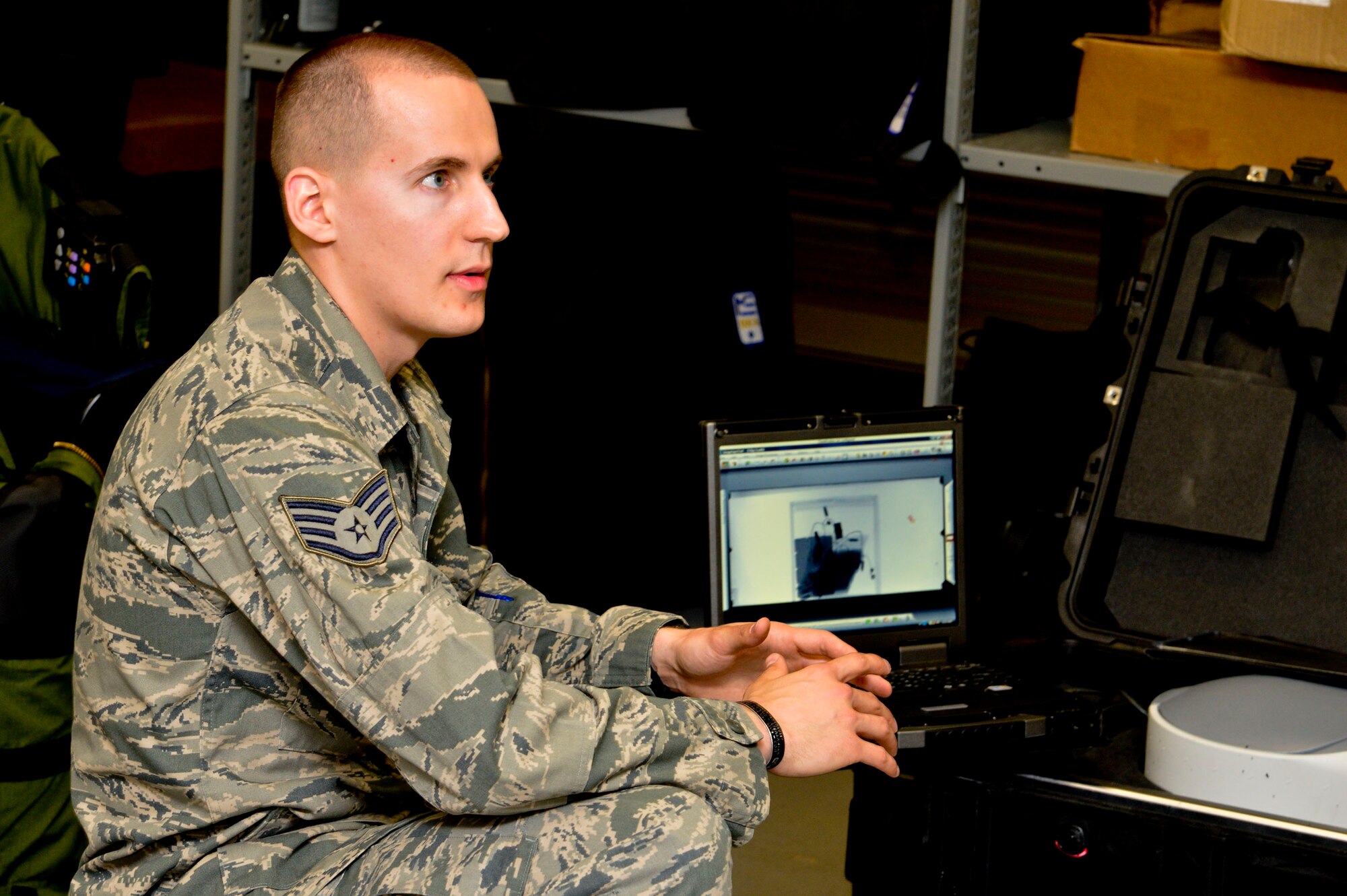 Staff Sgt. Benjamin McGovern, from the 436th Civil Engineer Squadron Explosive Ordnance Disposal Flight, demonstrates the XRS-300 portable X-ray system used by him and his team to render explosives safe at Dover Air Force Base, Del., April 16, 2013. The Media Day was an opportunity for media representatives to get a closer look at and a better understanding of Dover AFB's EOD Airmen and mission.  (U.S. Air Force photo/David S. Tucker)
