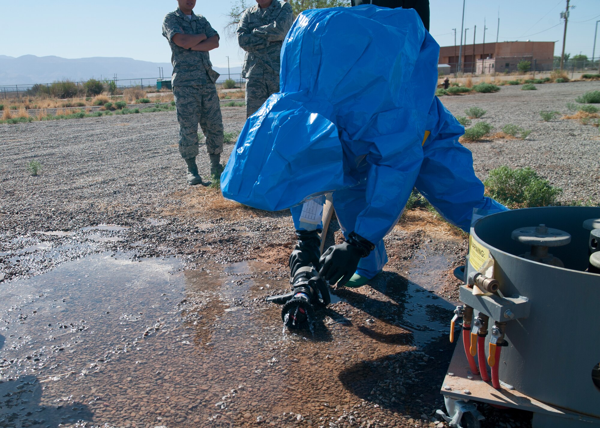 Staff Sgt. Amber Green, 49th Civil Engineer Squadron emergency management, shuts off a simulated chemical leak during a training scenario at Holloman Air Force Base, N.M., April 18. Airmen in bioenvironmental contain and emergency management undergo integrated base emergency response capability training to keep their skills sharp at all times. (U.S. Air Force photo by Airman 1st Class Daniel E. Liddicoet/Released)