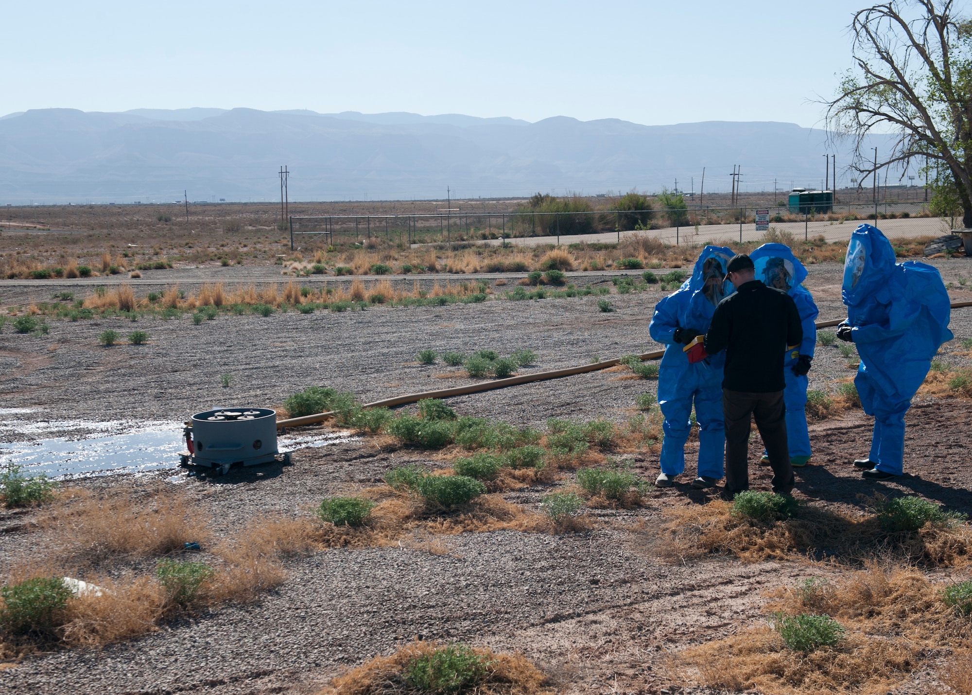 Airmen from the 49th Civil Engineer Squadron bioenvironmental engineering and emergency management units are briefed on a training scenario at Holloman Air Force Base, N.M., April 18. Airmen in both units regularly undergo integrated base emergency response capability training to keep their skills sharp at all times. (U.S. Air Force photo by Airman 1st Class Daniel E. Liddicoet/Released)