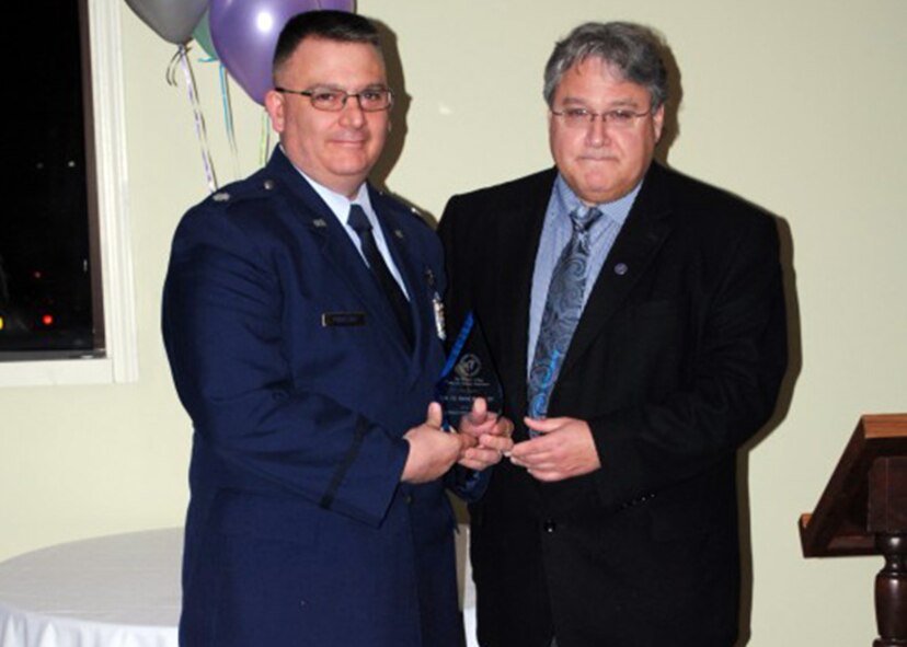 Lt. Col. Patrick E. Perretta (left), 914th Aeromedical Evacuation Squadron, receives the Daemen College Community Leadership Award from Dr. Michael S. Brogan, Daemen Vice President for Academic Affairs April 6, 2013 Amherst, N.Y.  Lt. Col. Peretta, who is stationed at the Niagara Falls Air Reserve Station, N.Y., was selected for the award in recognition for his outstanding work with veterans at the college.  (Courtesy Photo)