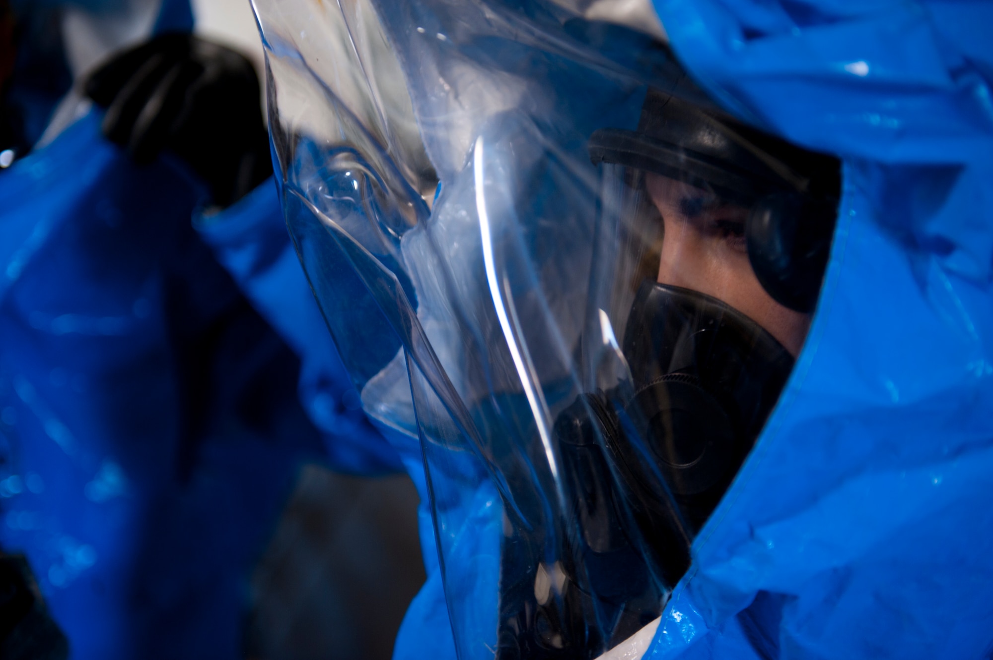 Airman 1st Class Lucas Montoya, 49th Civil Engineer Squadron bioenvironmental engineer, dons a hazmat suit to prepare for integrated base emergency response capability training at Holloman Air Force Base, N.M., April 18. Airmen working for bioenvironmental engineering and emergency management ran through a training scenario where they had to identify the source of a simulated chemical spill and contain it. (U.S. Air Force photo by Airman 1st Class Daniel E. Liddicoet/Released)