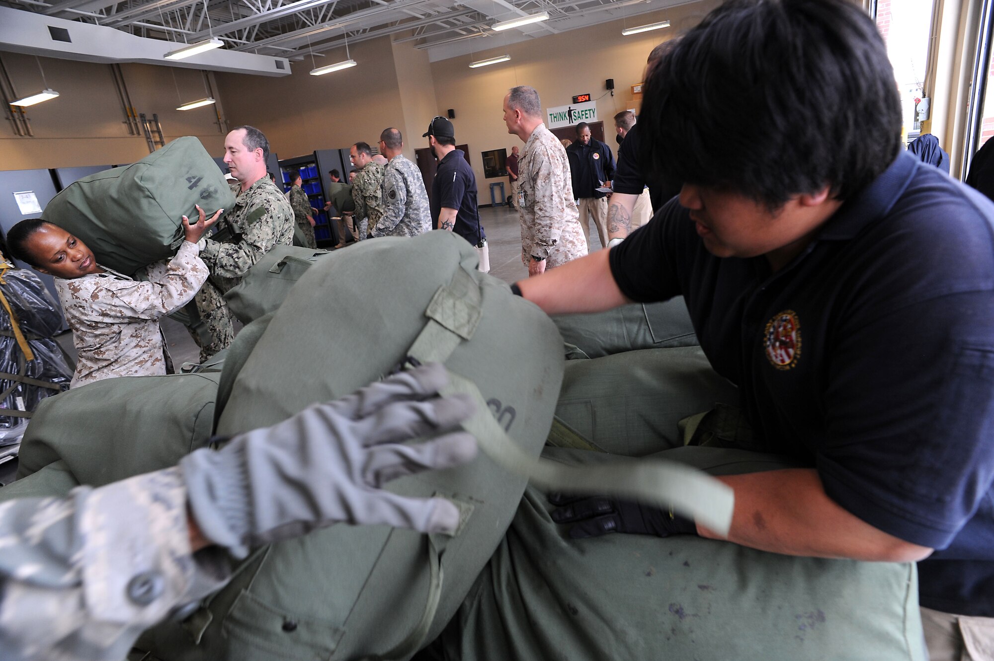 Joint Task Force Civil Support personnel load sea bags as part of a deployment readiness exercise at Fort Eustis, Va., April 16, 2013. When directed, JTF-CS provides command and control of more than 5,200 federal military forces, known as the Defense Chemical, Biological, Radiological, Nuclear Response Force, located at more than 36 locations throughout the U.S. It also plans for and responds to catastrophic CBRN events in the homeland in support of federal, state and local authorities. (Department of Defense photo by Marine Corps Gunnery Sgt. Jim Goodwin/Released)