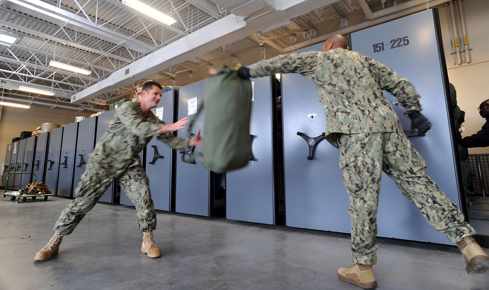 U.S. Navy Petty Officers 1st Class Reginald J. Holloway, supply lead petty officer, and Willie C. Fowler, Jr., Joint Task Force Civil Support deployment readiness noncommissioned officer in charge, load sea bags as part of a four-day deployment readiness exercise at Fort Eustis, Va., April 16, 2013. When directed, JTF-CS provides command and control of more than 5,200 federal military forces, known as the Defense Chemical, Biological, Radiological, Nuclear Response Force, located at more than 36 locations throughout the U.S. It also plans for and responds to catastrophic CBRN events in the homeland in support of federal, state and local authorities. (Department of Defense photo by Marine Corps Gunnery Sgt. Jim Goodwin/Released)