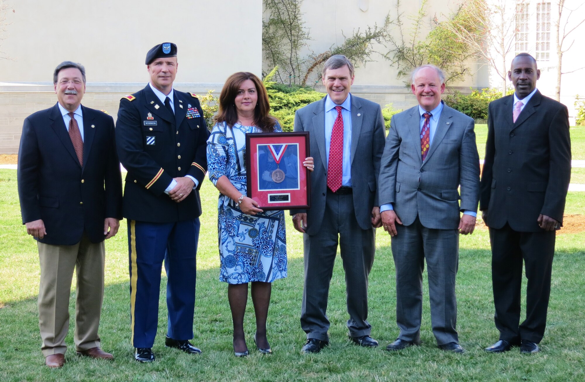 (From left) Doug Domenech, Virginia Secretary of Natural Resources; U.S. Army Col. Thomas Wetherington, 733rd Mission Support Group commander; Susan Miller, 733rd Civil Engineer Division environmental chief; David Paylor, director of the Virginia Department of Environmental Quality; David Johnson, director of the Virginia Department of Conservation and Recreation; and Don Johnson, 733rd Civil Engineer Division environmental element, showcase the 2013 Virginia Governor’s Environmental Excellence Gold Medal Award presented to the 733rd CED at the Governor's Award Dinner in Lexington, Va., April 10, 2013. The division earned the award for its significant contributions toward environmental protection and conservation in the sustainability category over the past five years through its Environmental Management System. (Courtesy photo/Released)
