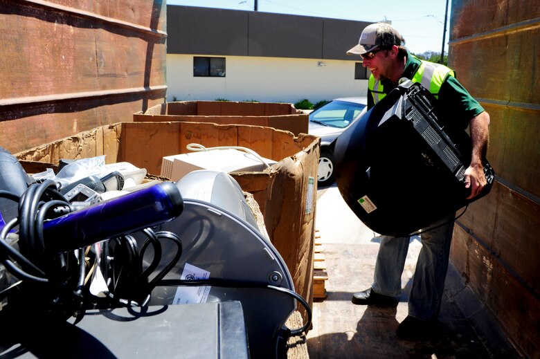 VANDENBERG AIR FORCE BASE, Calif. – Mike Andrews, Waste Management route manager, prepares to load a “bubble” television into a box with other electronic waste products during the 13th annual Earth Day event hosted by the 30th Civil Engineer Squadron here Thursday, April 18, 2013. Waste Management collects e-waste, anything with an electrical cord, to recycle properly promoting environmental health. (U.S. Air Force photo/Senior Airman Lael Huss)