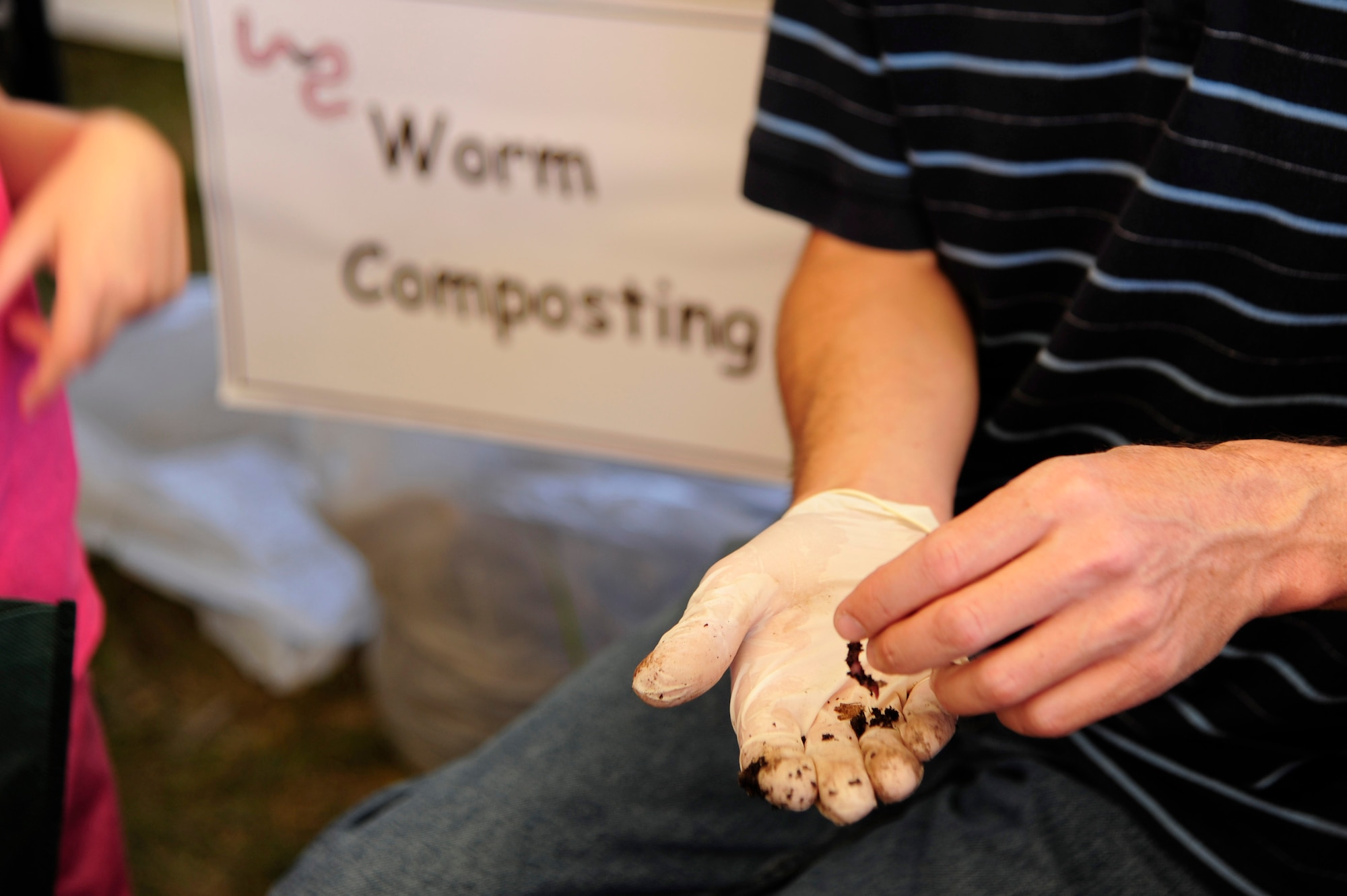 VANDENBERG AIR FORCE BASE, Calif. – A local vendor shows children earthworms used in worm composting during the 13th annual Earth Day event hosted by the 30th Civil Engineer Squadron here Thursday, April 18, 2013. Worm composting uses worms to recycle food scraps and other organic material that turns into nutrient rich compost, which is ideal for growing plants. (U.S. Air Force photo/Senior Airman Lael Huss)