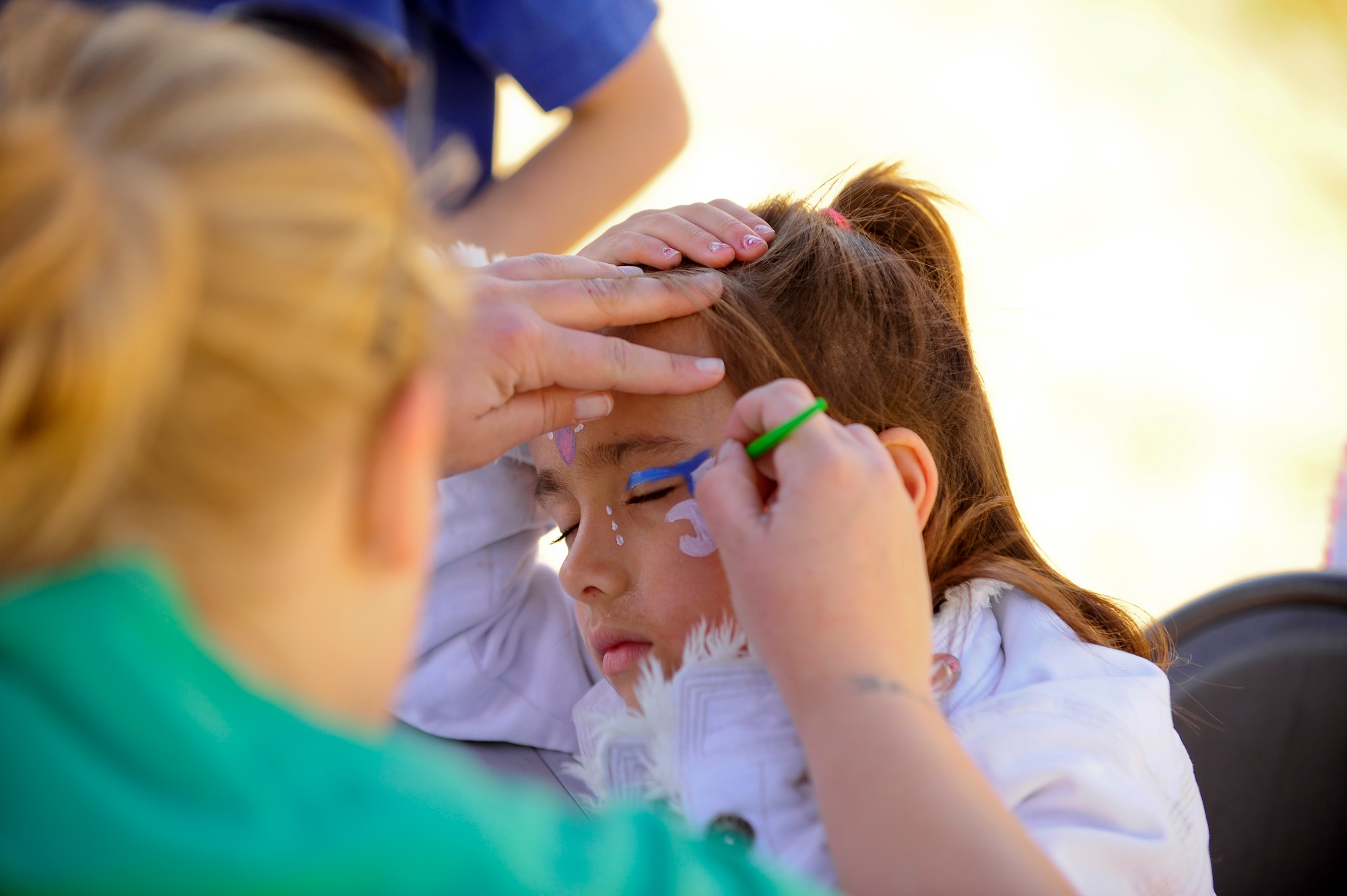 VANDENBERG AIR FORCE BASE, Calif. – The daughter of Senior Master Sgt. Eric Faulkenberry, 14th Air Force first shirt, has her face painted during the 13th annual Earth Day event here Thursday, April 18, 2013. Celebrated by millions of people on April 22, Earth Day promotes awareness and appreciation for the environment. (U.S. Air Force photo/Senior Airman Lael Huss)