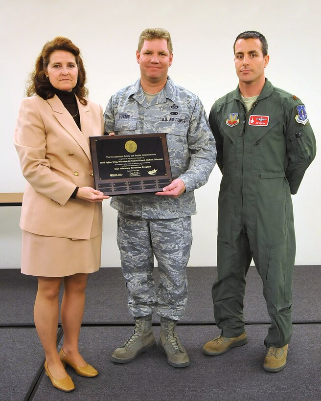 115th Fighter Wing safety NCOIC, SMSgt Thomas Egstadt, and Chief of Safety, Maj Joseph Walter, accept recognition for the Wing's second consecutive "star" rating in the Occupational Safety and Health Administration's Vountary Protection Program by Madison Area OSHA director Kim Still, April 11, 2013. (U.S. Air National Guard photo by MSgt Paul Gorman)