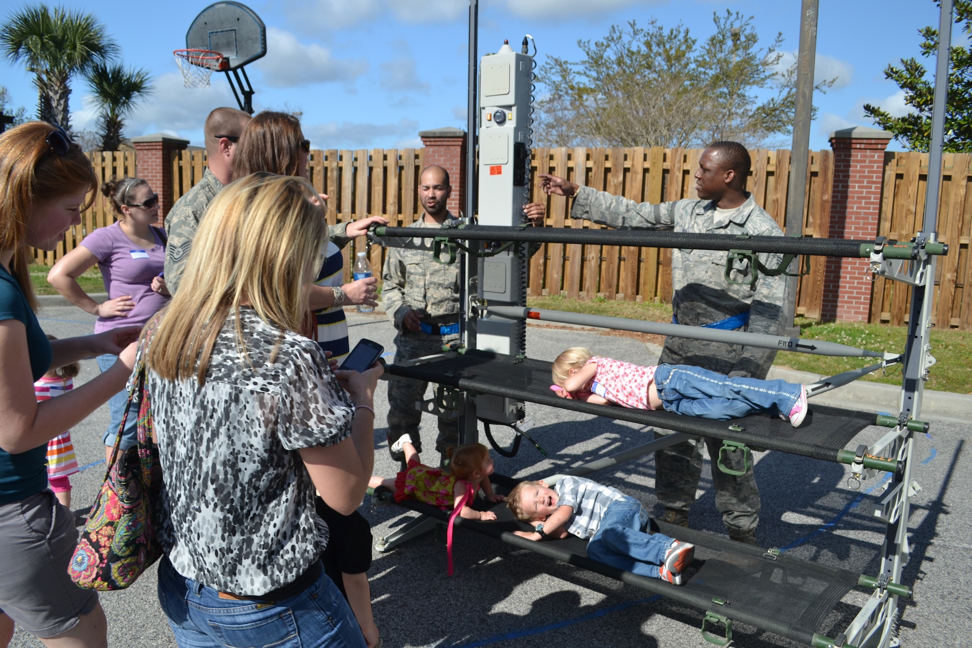 Airmen from the 437th Aircraft Maintenance Squadron brief spouses and children on equipment from a liter station augmentation set during the 437th AMXS Spouses Tour, April 10, 2013 at Joint Base Charleston – Air Base, S.C. This equipment is used for Aeromedical Evacuations on the C-17 More than 75 family members participated in the tour, which included informative briefings on AMXS, JB Charleston, C-17 Globemaster III capabilities and also consisted of various maintenance equipment set-up to include an aircraft tow vehicle, a bread truck (vehicle used to shuttle personnel around the flightline), and a tire chariot. (TSgt Marc Disbrow)