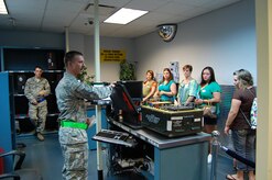 Tech. Sgt. Lewis Barkley, 437th Aircraft Maintenance flight line support section noncommissioned officer in charge, briefs spouses on a tire-change kit during a 437th AMXS Spouse Tour, April 10, 2013 at Joint Base Charleston – Air Base, S.C. More than 75 family members participated in the tour, which included informative briefings on AMXS, JB Charleston, C-17 Globemaster III capabilities and also consisted of various maintenance equipment set-up to include an aircraft tow vehicle, a bread truck (vehicle used to shuttle personnel around the flightline), and a tire chariot. (U.S. Air Force photo/ 2nd Lt. Andrea Gehrman)