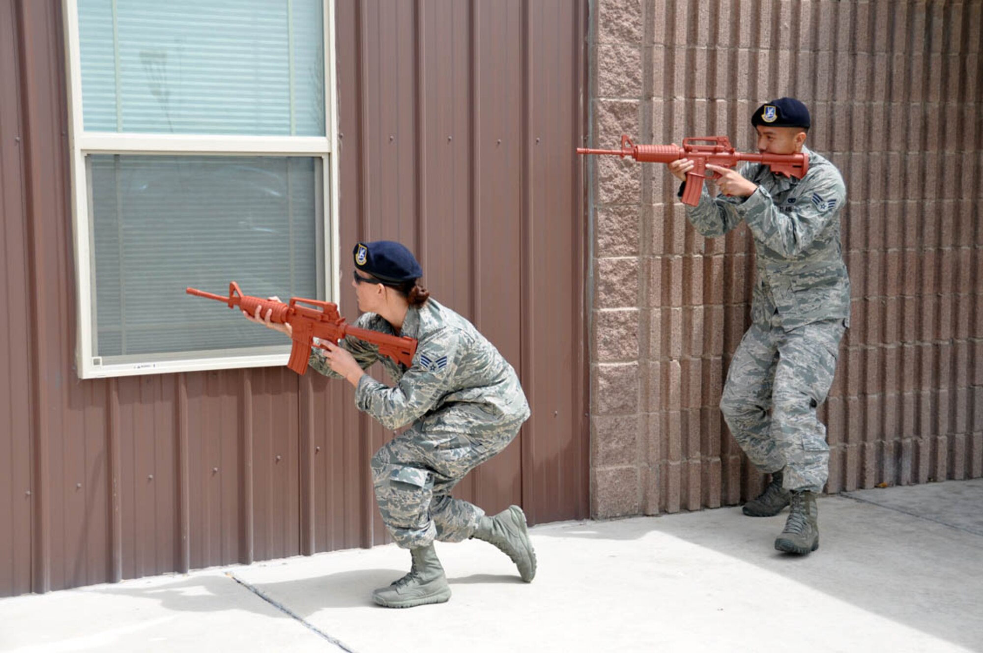 NELLIS AIR FORCE BASE, Nev. -- (Right) Senior Airmen Michael Legaspi and Jessica Rayl, 926th Security Forces Squadron, train on how to clear a building after a simulated alarm activation here April 7, 2013. (U.S. Air Force photo/Maj. Jessica Martin)