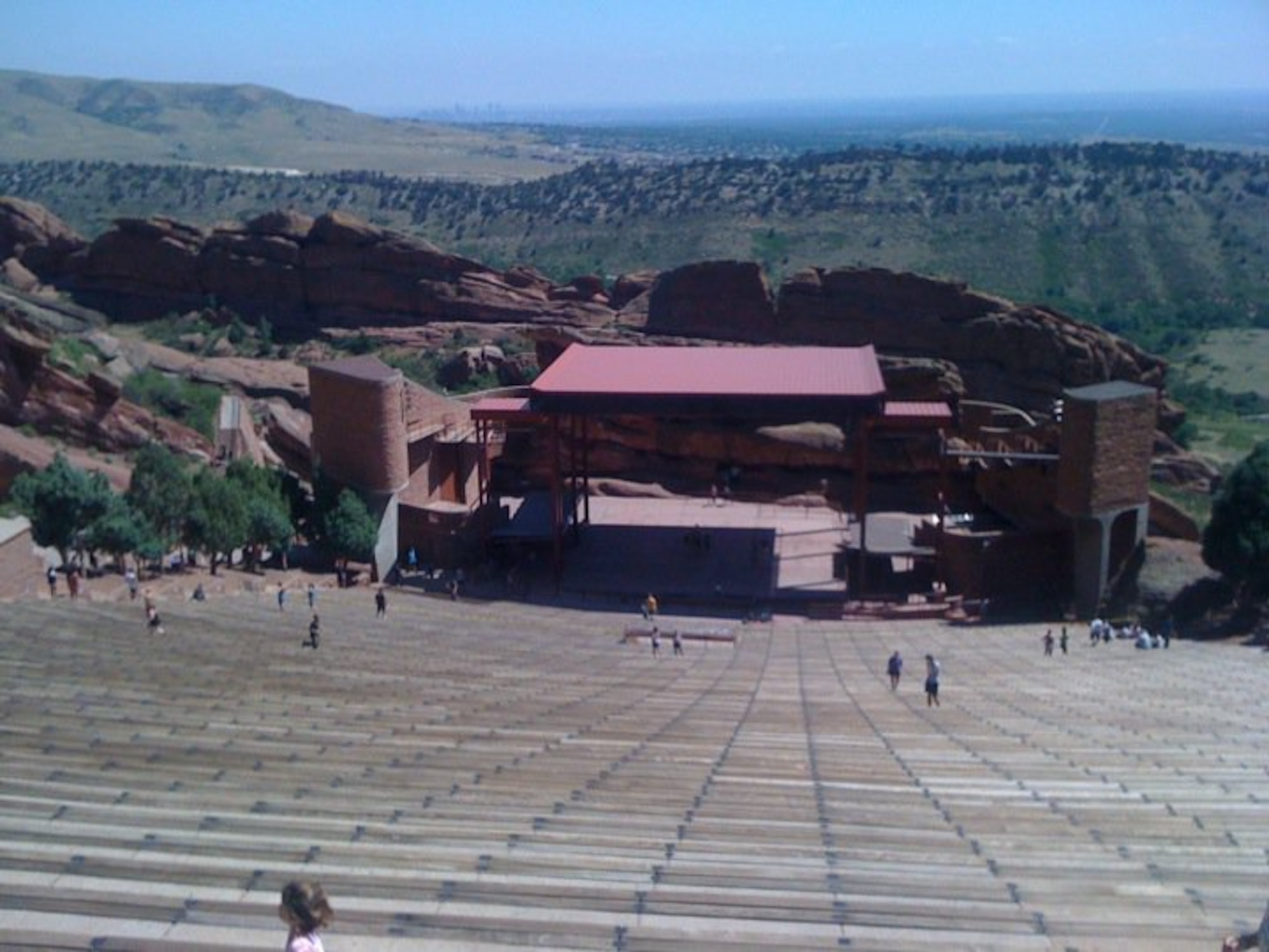Sightseers and joggers running the 69 rows of seating enjoy the view from 6,450 feet above sea level from the 9,450 person capacity amphitheatre at Red Rocks Park overlooking the city of Denver. (U.S. Air Force photo by Senior Airman Daniel Gage)  