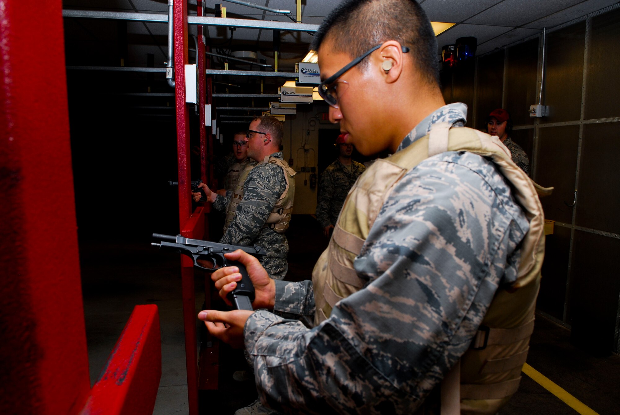 Second Lt. William Liaw, 56th Comptroller Squadron financial services officer, inserts a magazine clip into the M-9 pistol during the weapons competition portion of the immersion at Combat Arms Training and Marksmanship. Liaw placed first with a total score of 79. (U.S. Air Force photo/Airman 1st Class David Owsianka)