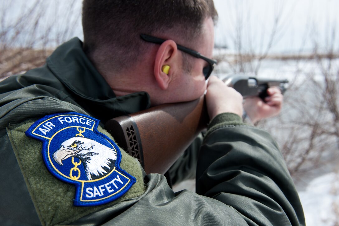 Maj. Jim Ellis, 28th Bomb Wing flight safety officer and B-1 pilot, shoots nonlethal bird scare ammunition into the air to scare geese and ducks away from the airfield on Ellsworth Air Force Base, S.D., March 26, 2013. When certain wildlife get too close to the airfield, Airmen assigned to the Bird Aircraft Strike Hazard program are required remove the flying wildlife from the area to prevent safety hazards. (U.S. Air Force photo by Airman 1st Class Kate Thornton/Released)
