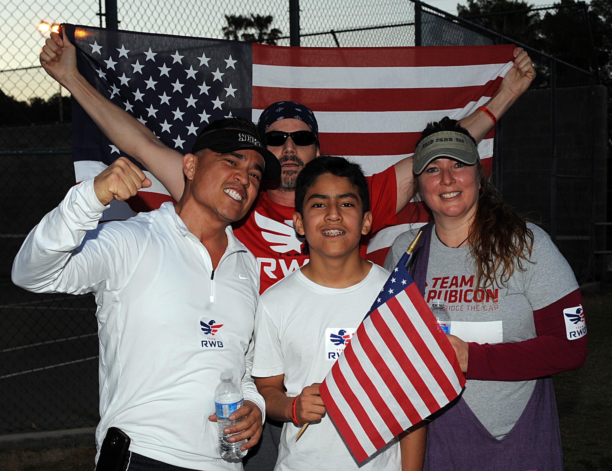 Members of Team Red, White and Blue-Tucson pose for a photo after completing a three-mile run as part of Team RWB-Tucson’s Boston Marathon Attack Response Run in Tucson, Ariz., April 17, 2013. Approximately 50 people attended the event to show their support for those affected by the Boston Marathon bombings. (U.S. Air Force photo by Senior Airman Timothy Moore/Released)