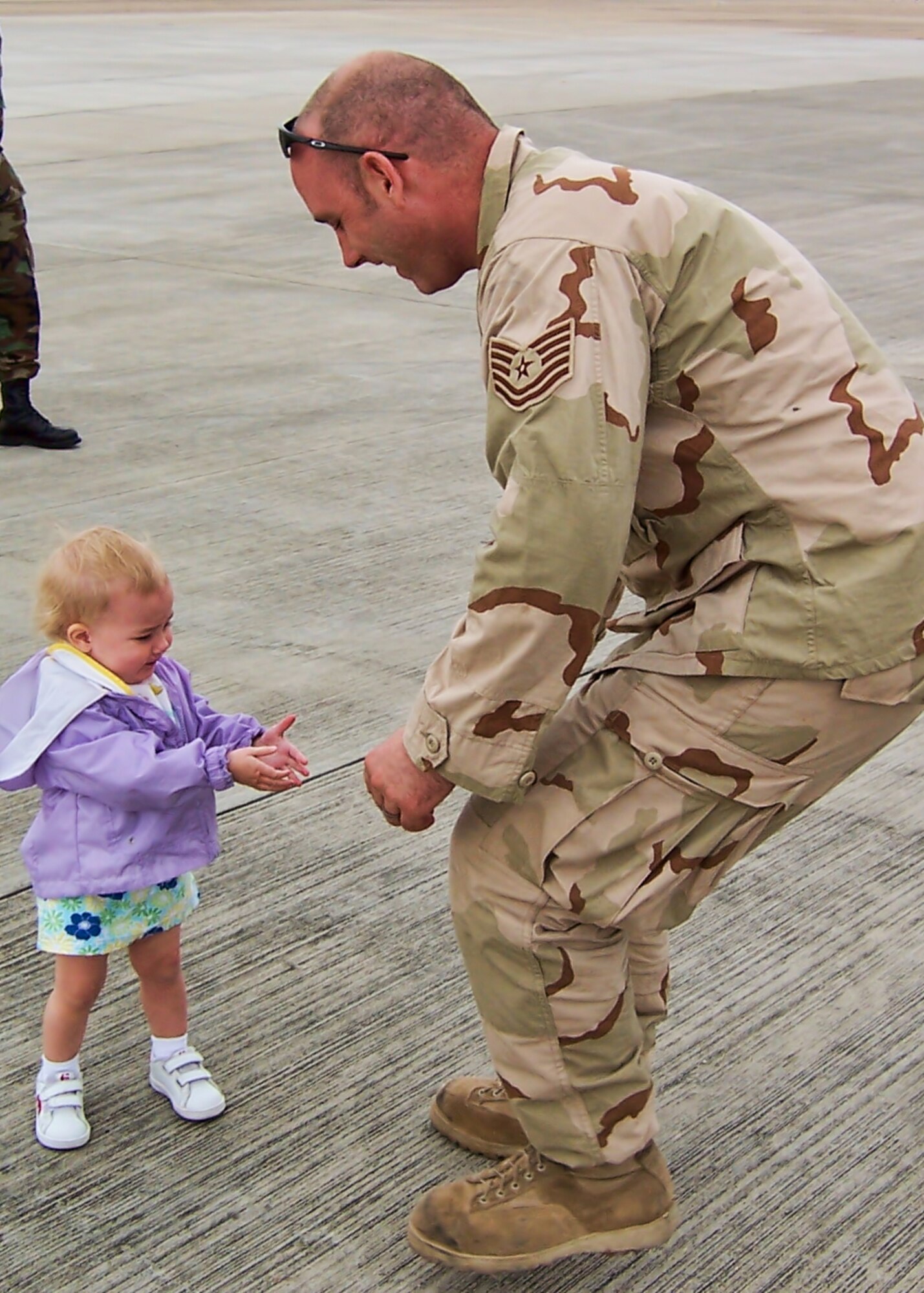 Fifteen-month-old Zoeigh Haskell greets her daddy, then-Tech. Sgt. James Haskell, at Royal Air Force Station Mildenhall, England, upon his return from deployment in support of Operation Iraqi Freedom in 2006. Haskell was an aerial gunner at the time and now suffers from Post Traumatic Stress Disorder. His wife, Melissa, and two daughters, Zoeigh, now 8, and Leslie, 4, have been a source of strength through his recovery. (Photo by Melissa Haskell)
