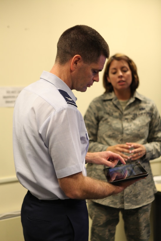 Col. David Murphy (fore), 782nd Training Group commander, works with the new mobile app "Torqued" on a tablet device with help from Tech. Sgt. Lisa Parker, 367th Training Support Squadron, during a visit to Hill Air Force Base, Utah, April 18, 2013.  “Torqued”, the first major mobile application release by the 367th TRSS' Instructional Training Unit (ITU), was designed to allow Air Force maintainers to calculate complicated torque settings on-the-fly while on the flight line.  (U.S. Air Force photo/Staff Sgt. Aaron Nelson)